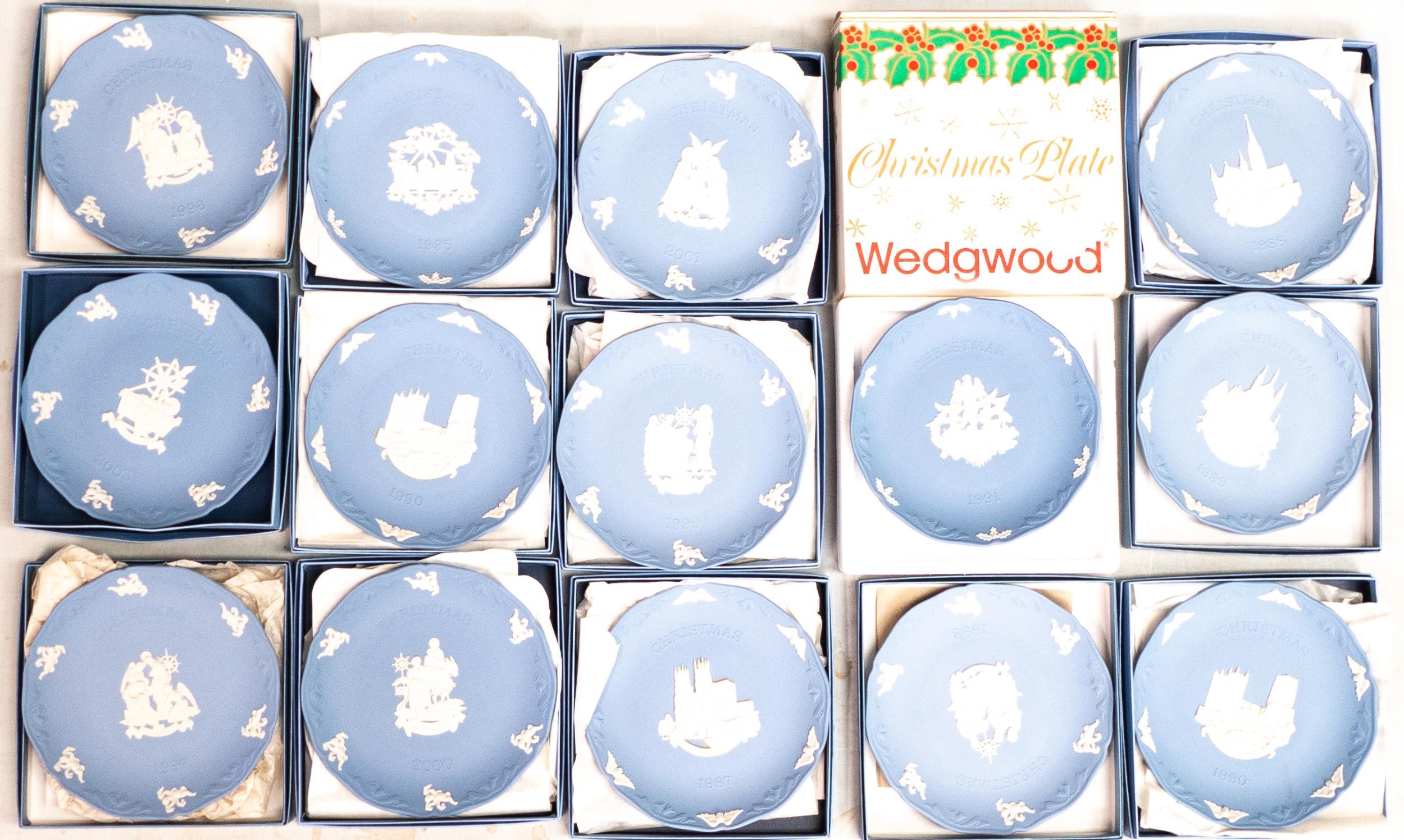 A collection of boxed Wedgwood Jasperware year plates, diameter 19cm (14)