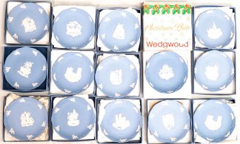 A collection of boxed Wedgwood Jasperware year plates, diameter 19cm (14)