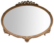 Large oval carved bevel edged wall mirror with foliage & ribbon decoration, diameter at widest 144cm