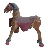 Early 20th century Pull Along horse. Crafted with real horsehide and hair, on wooden bars with tin