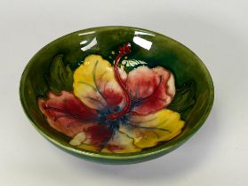Moorcroft Orchid pattern on green ground shallow footed bowl, diameter 11.5cm