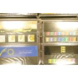 Six large and fairly full albums containing 160 appx mint presentation packs / mint sets of modern