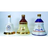 Three Un Sealed Bells Pottery Whiskey Decanters including Royal Commemorative & Christmas Theme