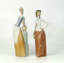Two Nao figurines one of a lady with a butterfly in her hand together with lady with riding whip (