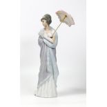 Lladro figurine of a lady in her evening dress holding an umbrella. Height 27cm