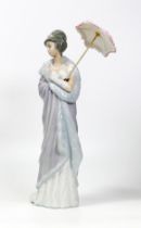 Lladro figurine of a lady in her evening dress holding an umbrella. Height 27cm