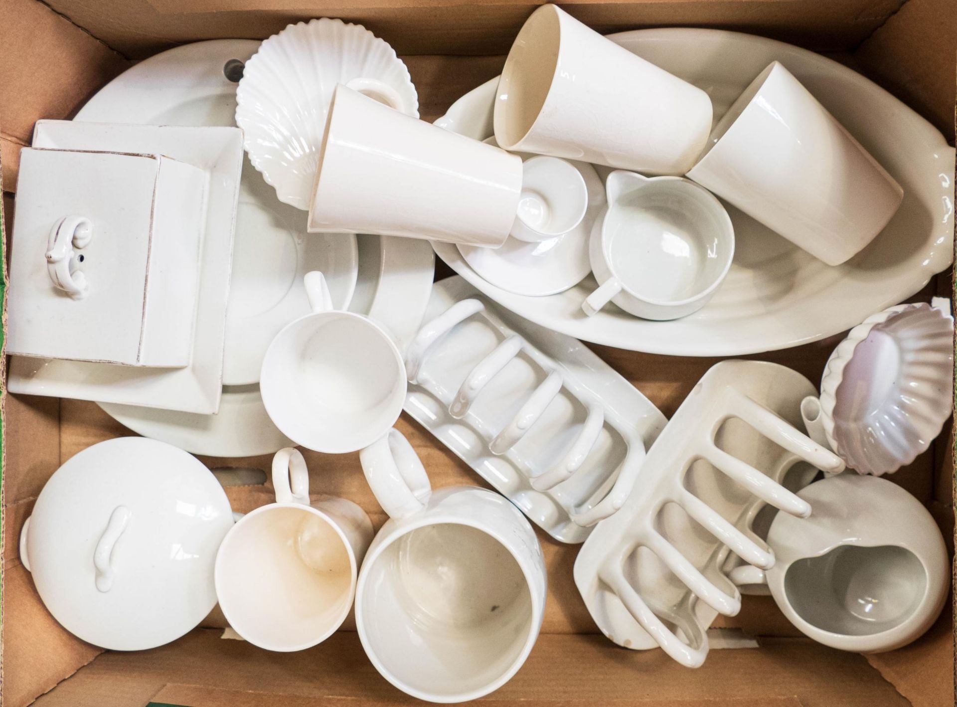 A collection of white Shelley ware to include toast racks, beaker, mugs, lidded broth bowl etc (18)