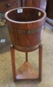R. A. Lister & Co Ltd oak planter in coopered barrel form, height 67cm.