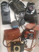 A collection of vintage camera equipment to include Pentax, Olympus and Kodak examples, plus