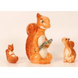 Beswick comical squirrel family comprising Squirrel with nutcracker 1009, seated 1007 and lying