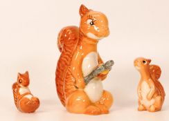 Beswick comical squirrel family comprising Squirrel with nutcracker 1009, seated 1007 and lying