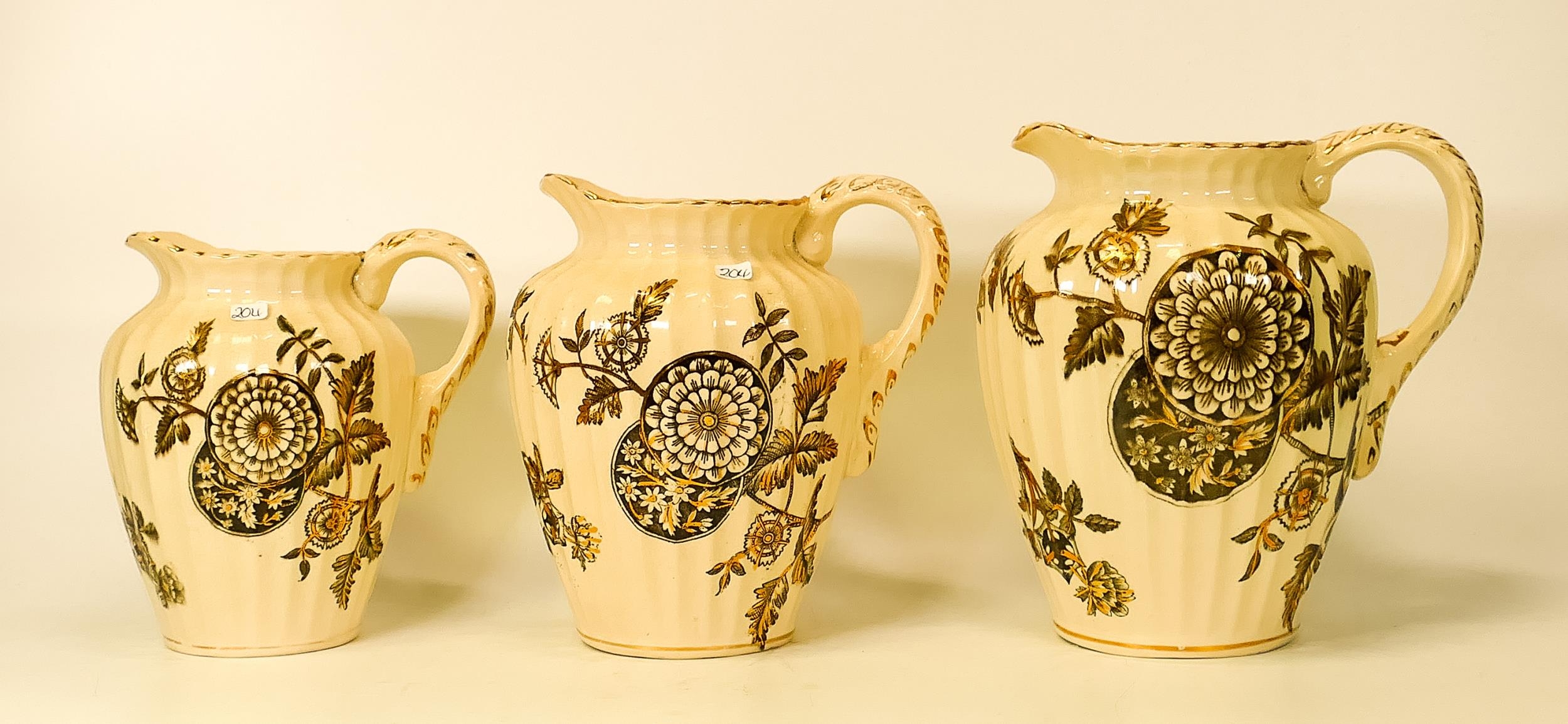 S. F & Co Delhi patterned set of three graduated jugs. Height of tallest 19cm