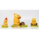 three winnie the pooh figures to include pooh began to eat WP28, WP36, pooh in a party hat