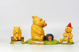 three winnie the pooh figures to include pooh began to eat WP28, WP36, pooh in a party hat