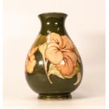 Moorcroft Hibiscus vase on green background. Height 21.5cm