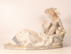 Large Nao Figure of Lady Lying Down near rocks, height 24cm