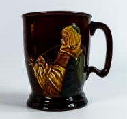Royal Doulton Kingsware mug, decorated in relief with a man smoking, the reverse with slip motto