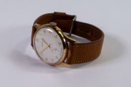 9ct gold Garrard gentleman's mechanical wristwatch, seconds dial with leather strap, in original