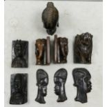 A collection of carved African book ends, wall masks together with a bust. Height of tallest 21cm