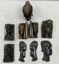 A collection of carved African book ends, wall masks together with a bust. Height of tallest 21cm