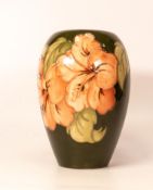 Moorcroft Hibiscus on green vase. Height 18cm