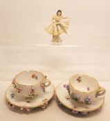 2 Meissen cabinet cup and saucer sets on stilts together with small Dresden lace figure.