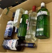 A collection of 6 70cl bottles of sealed spirits to include Smirnoff Vodka, Gordons Gin, Lambs