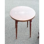 A Four Legged Circular Table on Fluted Column Legs. Top has signs of use and wear