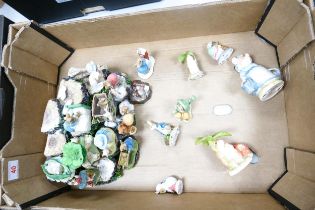 A collection of Border fine arts resin Beatrix Potter figures on a unmarked stand together with