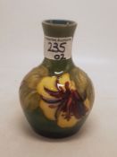 Moorcroft Hibiscus pattern vase on graduated green ground original paper label to base height 12.5cm