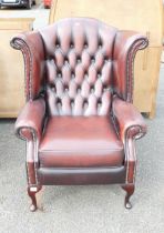 An Ox-blood Chesterfield Wingback Armchair on Queen Anne Legs