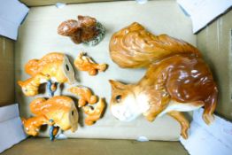 A collection of seven Squirrel figures to include Sylvac Red Squirrel, two Beswick Squirrel Cracking