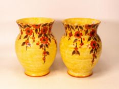 A pair of Crown Devon Fielding Mattita vases decorated with stylised flowers, marked M51 to base.