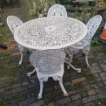 Painted white aluminium patio table and four chairs. Diameter of table 109cm