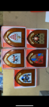 A collection of boxed wooden heraldic shields each with hand painted raised shield, including