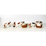 Royal Doulton dog figures to include puppies in basket, dog with plate, dog with ball , puppy in