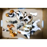 A collection of fifteen Royal Doulton dogs to include Cocker Spaniel HN1078, Yawning Dog HN1099,