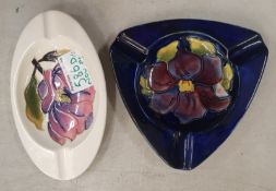 Moorcroft Clematis on blue ground triangular shaped ash tray together with Pink Magnolia oval Ash