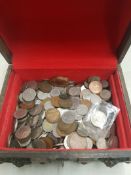 A collecton of decimal and pre decimal UK and world coins contained within a vintage oak storage box