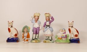 A collection of Reproduction Staffordshire type figures including fruit carriers, cats , pin cushion