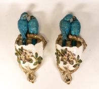 A Pair of Earthenware Wall Pockets, naturalistically moulded as Lovebirds perched above their nest