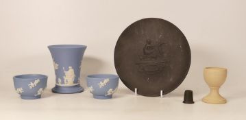 Wedgwood, Five items of Jasperware to include yellow eggcup, two blue prunus bowls and a small vase,