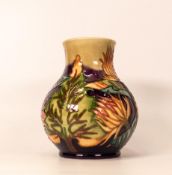Moorcroft vase decorated with trees and orange thistles. Dated 1999 to base. Height 16cm