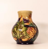 Moorcroft vase decorated with trees and orange thistles. Dated 1999 to base. Height 16cm