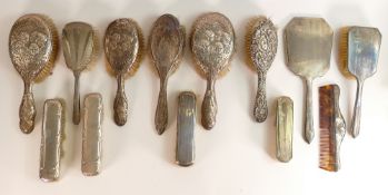 11 x hallmarked silver backed brushes, plus comb & mirror. Some decorated with cherubs (13)