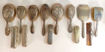 11 x hallmarked silver backed brushes, plus comb & mirror. Some decorated with cherubs (13)