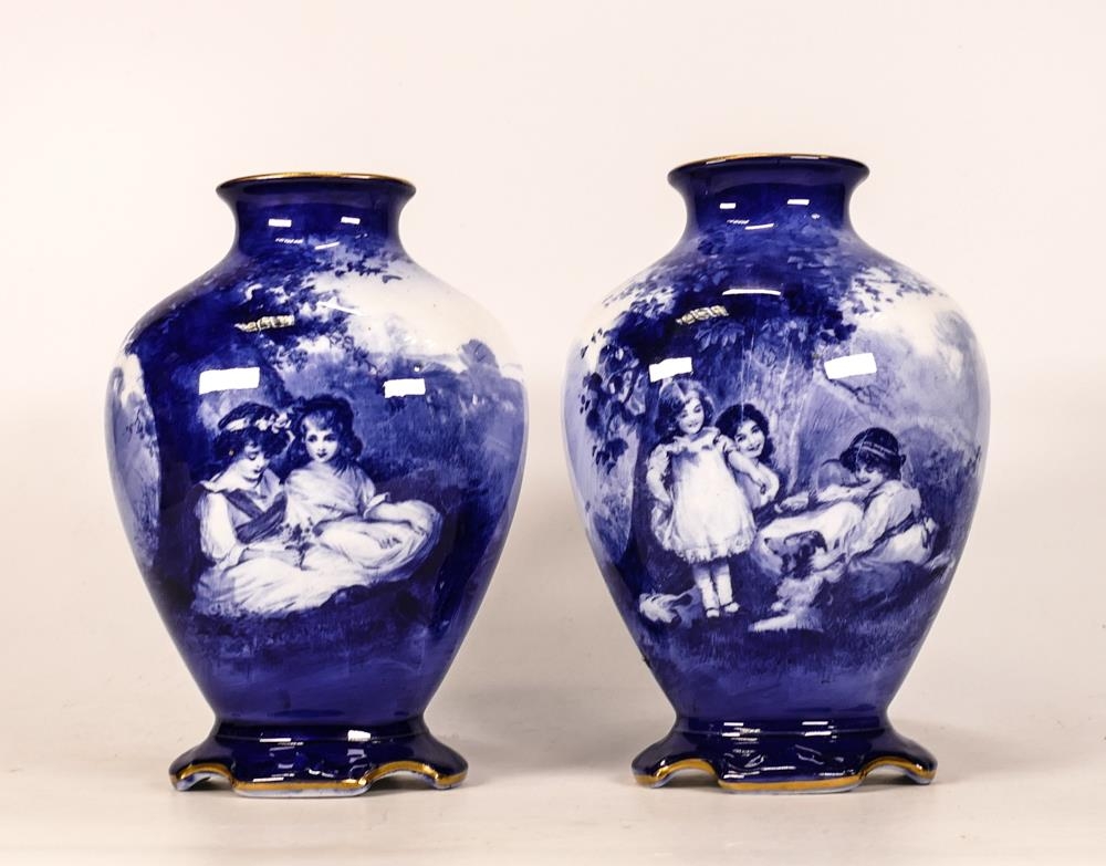 A pair of Royal Doulton blue & white vases with scenes of children