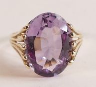 9ct gold ladies dress ring set with large purple oval stone, size N, 3.5g.