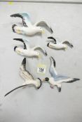 A collection of Mid Century pottery Seagull theme wall plaques, largest length 19cm(5)