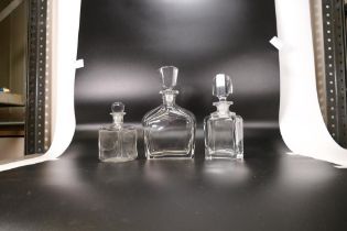 Three Glass Stoppered Bottles; to include two art deco large perfume bottles together with a smaller